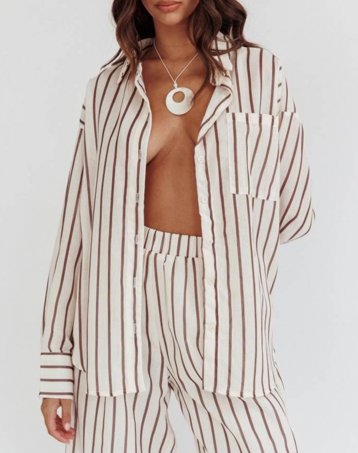 Complete your look with Latte Stripe Set: Oversized fit top and elastic waist pants.